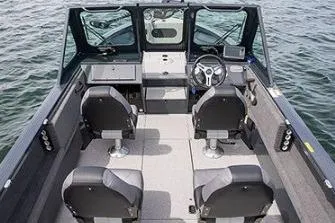 Slide: The Image of 2026 Crestliner 2050 Commander boat in a garage, black exterior, on a trailer. - 3