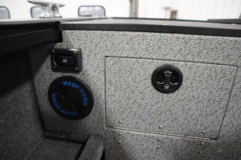 Slide: The Image of 2026 Crestliner 2050 Commander interior with wash down feature and storage compartment. - 34