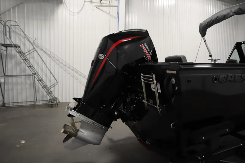 Slide: The Image of 2026 Crestliner 2050 Commander boat with powerful outboard motor in a garage setting. - 36