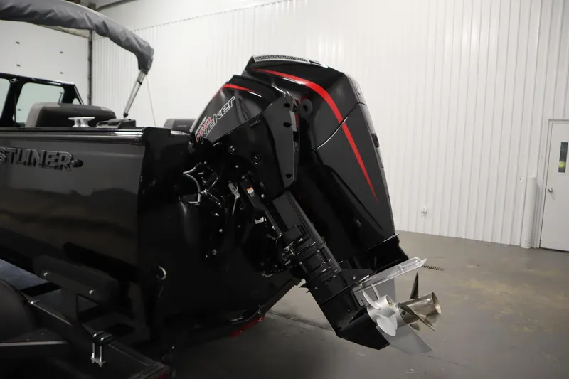 Slide: The Image of 2026 Crestliner 2050 Commander boat with powerful outboard motor in a showroom. - 37