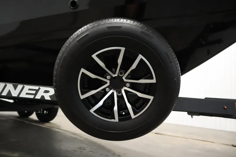 Slide: The Image of 2026 Crestliner 2050 Commander trailer wheel, black and silver design, close-up view. - 39