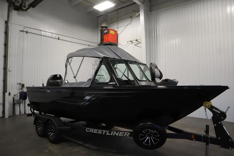 Slide: The Image of 2026 Crestliner 2050 Commander boat in a garage, on a trailer. - 42