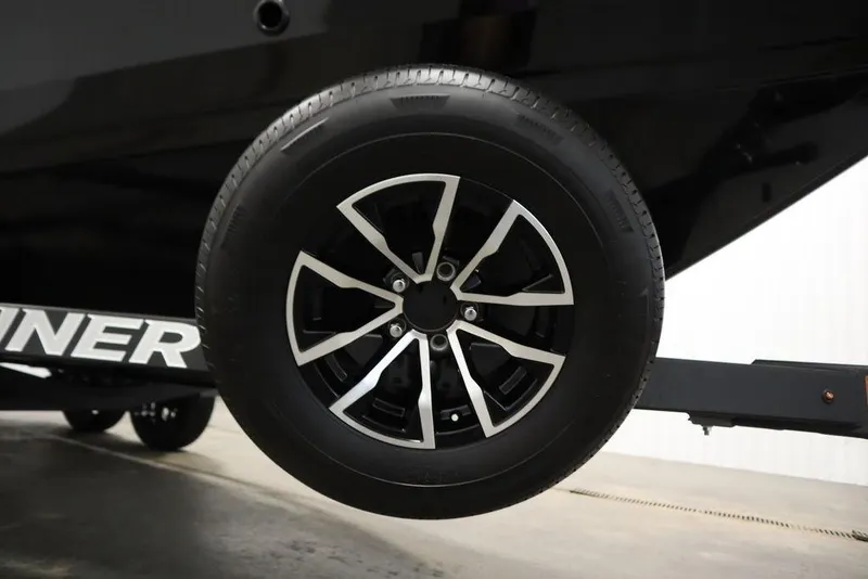 Slide: The Image of Trailer wheel of 2026 Crestliner 2050 Commander boat, featuring sleek black and silver design. - 46