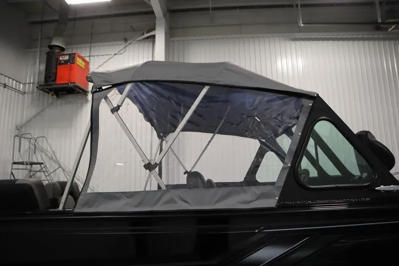 Slide: The Image of 2026 Crestliner 2050 Commander boat with canopy in indoor setting. - 55