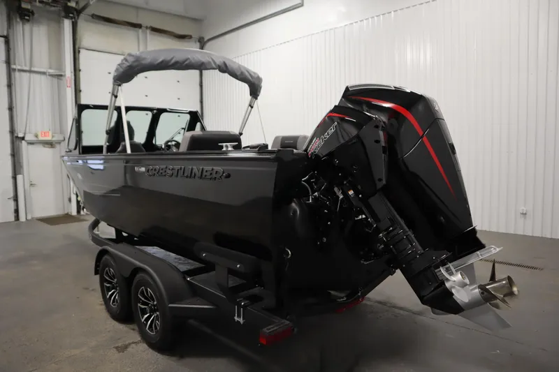 Slide: The Image of 2026 Crestliner 2050 Commander boat with powerful outboard motor in a garage setting. - 6