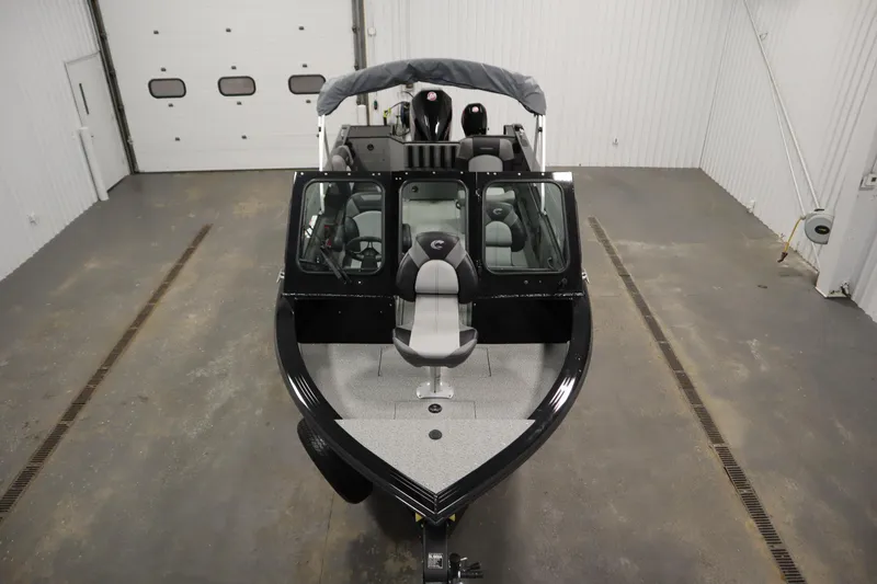 Slide: The Image of 2026 Crestliner 2050 Commander boat in a spacious indoor garage setting. - 8