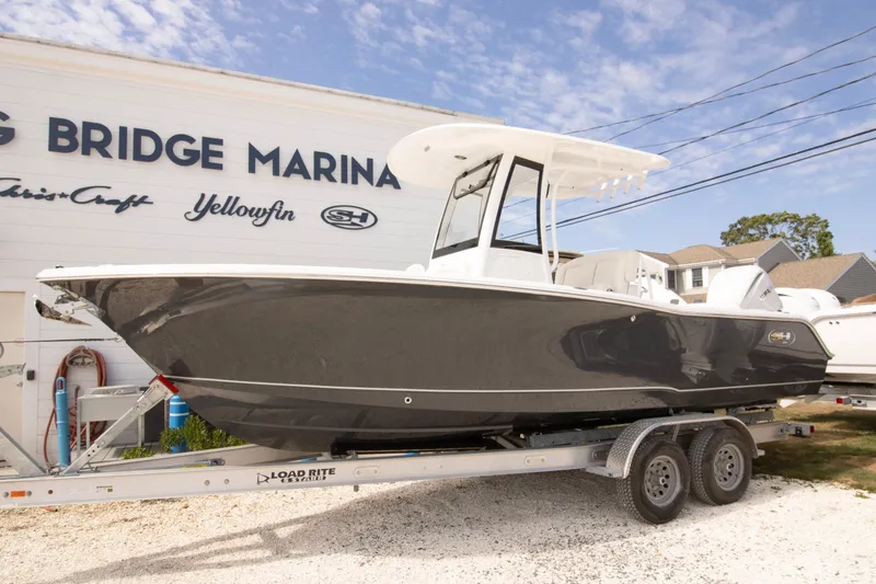 The Image of 2026 Sea Hunt Ultra 245 SE boat on trailer at marina. - 0