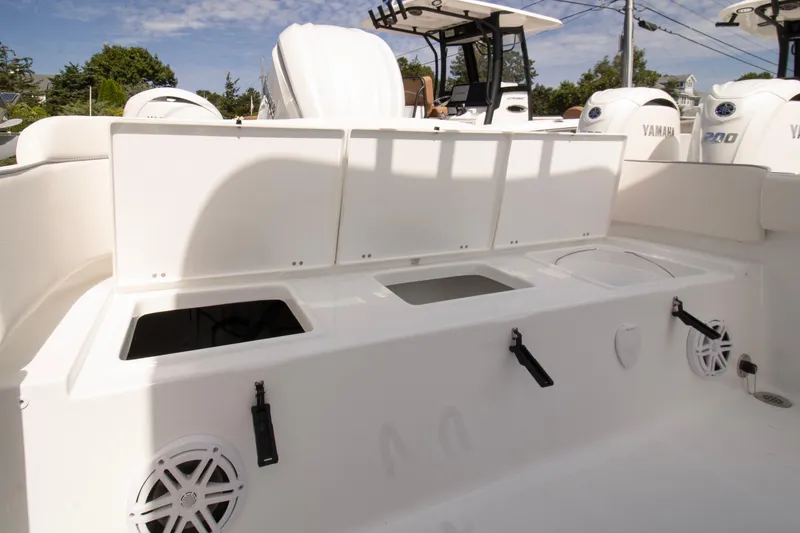 Slide: The Image of 2026 Sea Hunt Ultra 245 SE boat interior with storage compartments and Yamaha engines. - 11