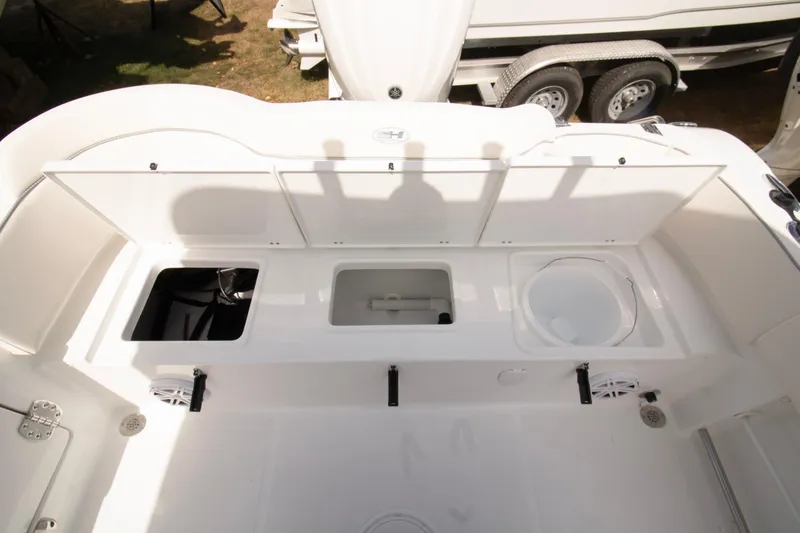 Slide: The Image of 2026 Sea Hunt Ultra 245 SE boat storage compartments and seating area. - 12