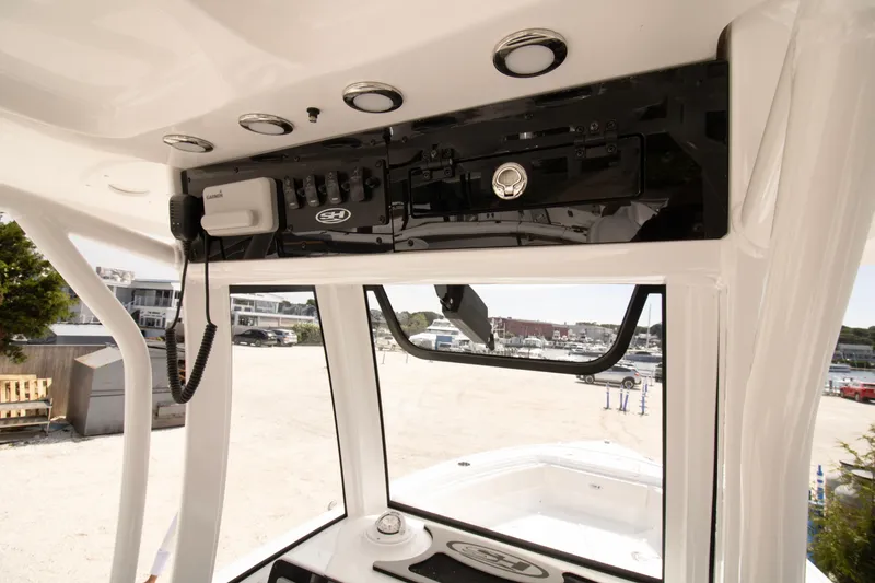 Slide: The Image of 2026 Sea Hunt Ultra 245 SE boat console with electronics and controls. - 7