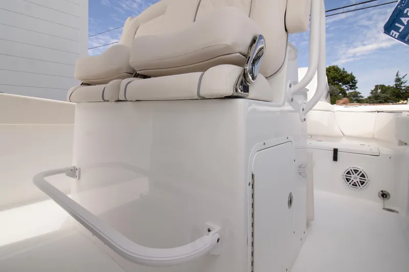 Slide: The Image of 2026 Sea Hunt Ultra 245 SE boat interior with white seating and storage compartment. - 8