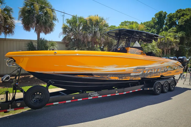 The Image of Bright orange 2016 Statement 380 Open boat on trailer, surrounded by palm trees. - 0