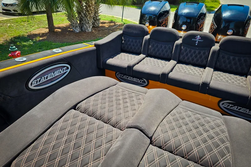 Slide: The Image of Luxurious seating on 2016 Statement 380 Open boat with quad engines, palm trees in background. - 12