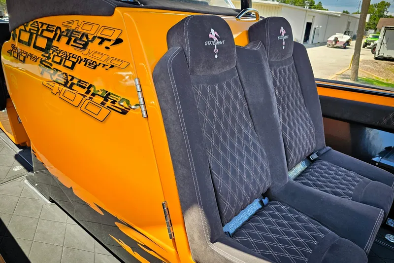 Slide: The Image of Orange Statement 380 Open 2016 boat interior with black diamond-stitched seats. - 22