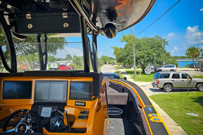Slide: The Image of Interior view of a 2016 Statement 380 Open boat with navigation screens and steering wheel. - 28