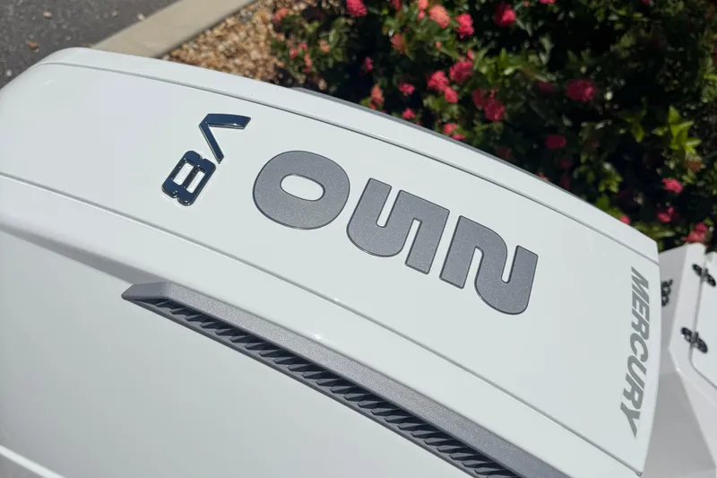 Slide: The Image of 2026 Blackfin 222 CC boat engine cover with Mercury branding, surrounded by flowers. - 11