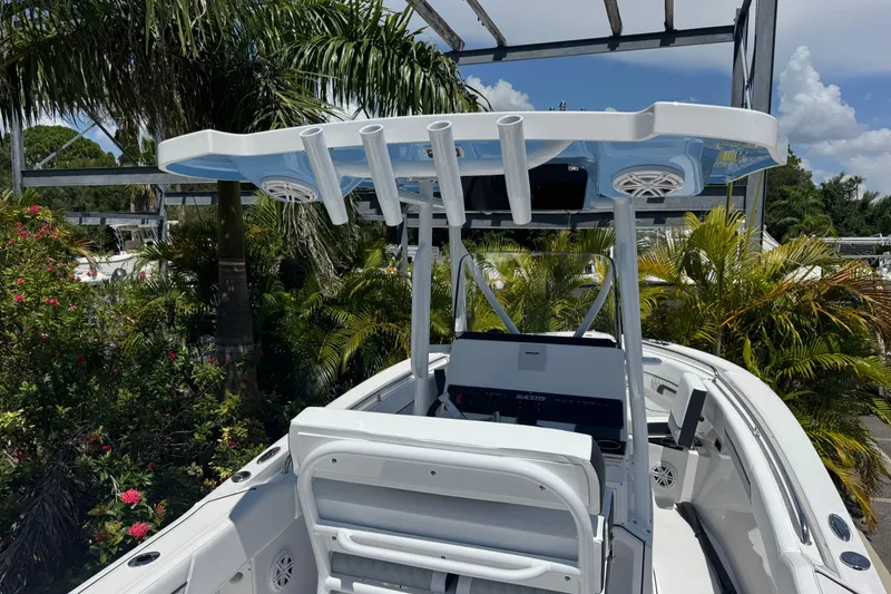 Slide: The Image of 2026 Blackfin 222 CC boat with T-top, surrounded by lush greenery. - 15