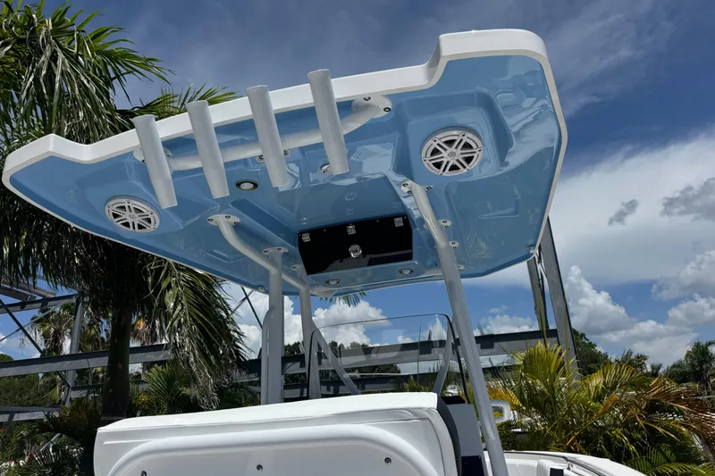 Slide: The Image of 2026 Blackfin 222 CC boat with blue T-top and speakers, set against a tropical backdrop. - 16