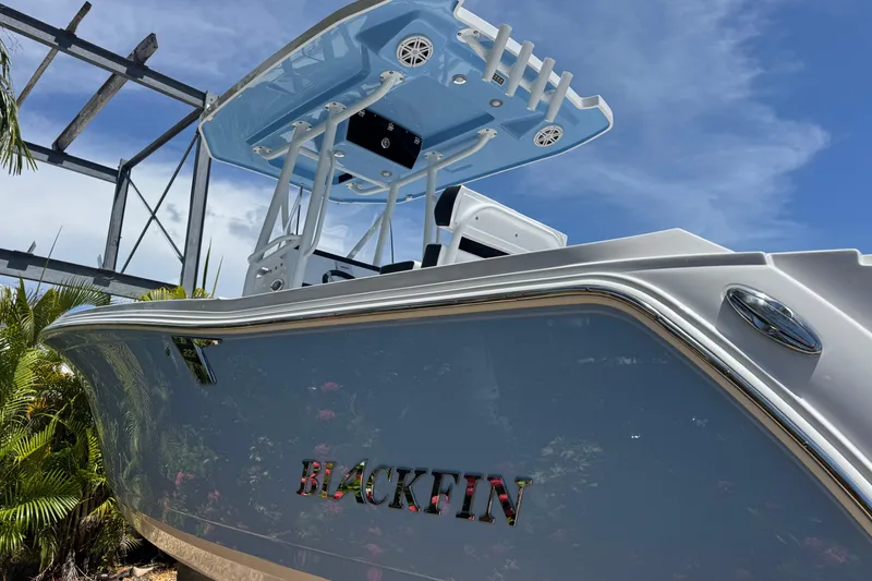 Slide: The Image of 2026 Blackfin 222 CC boat with sleek design under clear blue sky. - 7