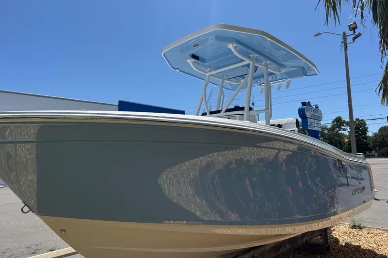 Slide: The Image of 2026 Blackfin 222 CC boat with sleek design under clear blue sky. - 9
