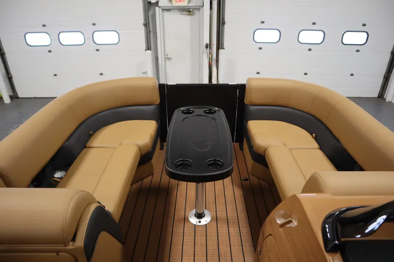 Slide: The Image of 2026 Bentley Pontoons Elite 223 Admiral Tri-toon interior with tan seating and table. - 10