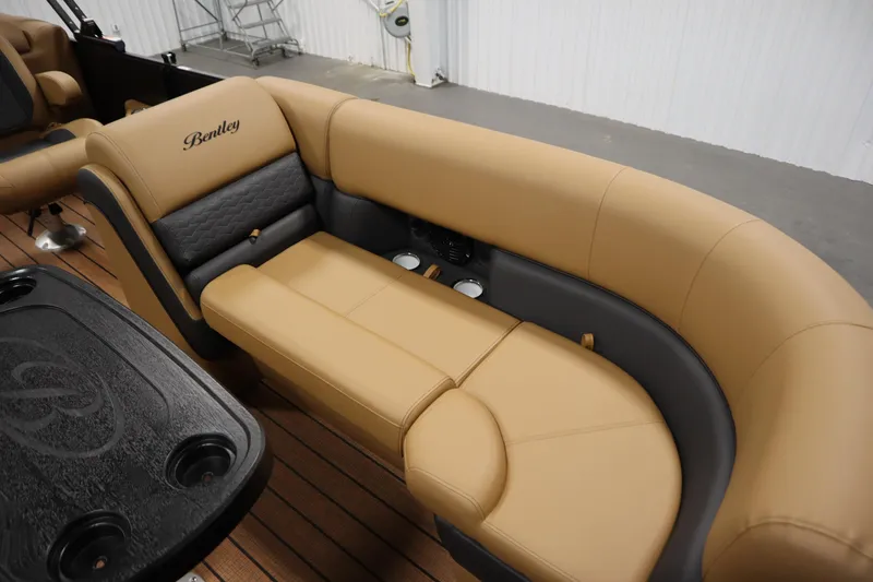 Slide: The Image of Luxurious seating in 2026 Bentley Pontoons Elite 223 Admiral Tri-toon, featuring tan and gray upholstery. - 11