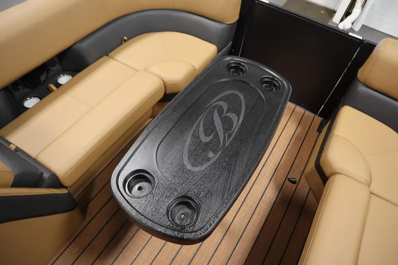Slide: The Image of 2026 Bentley Pontoons Elite 223 Admiral Tri-toon interior with tan seating and black table. - 16