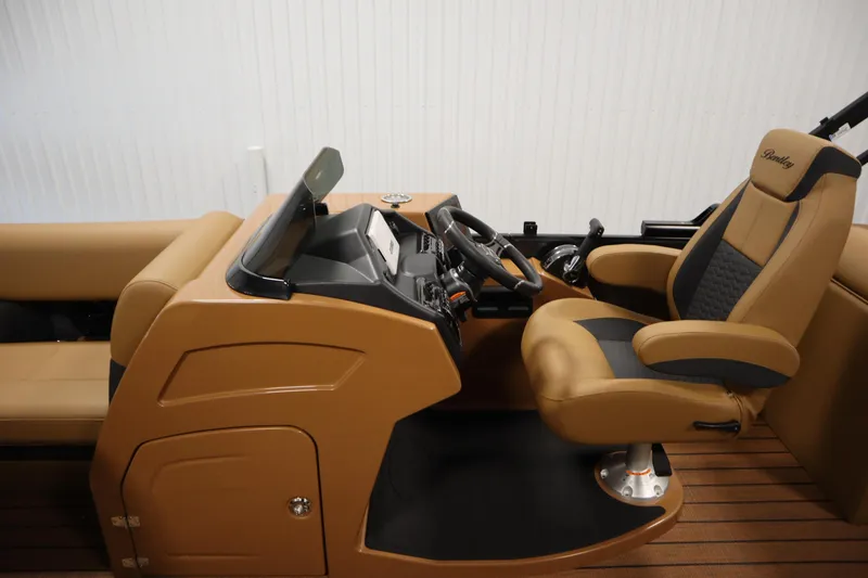 Slide: The Image of 2026 Bentley Pontoons Elite 223 Admiral Tri-toon helm with luxurious captain's chair and controls. - 19