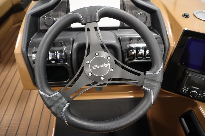 Slide: The Image of Steering wheel of 2026 Bentley Pontoons Elite 223 Admiral Tri-toon, featuring modern dashboard controls. - 21