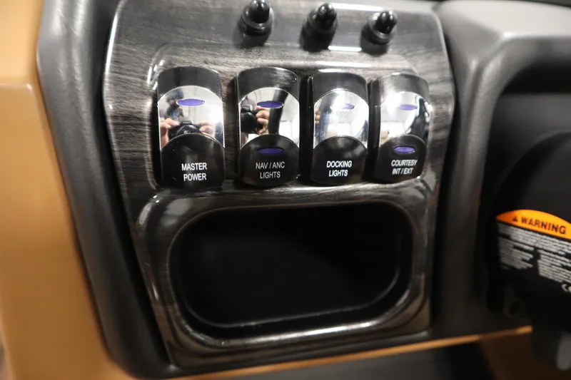 Slide: The Image of Control panel of 2026 Bentley Pontoons Elite 223 Admiral Tri-toon with labeled switches. - 23