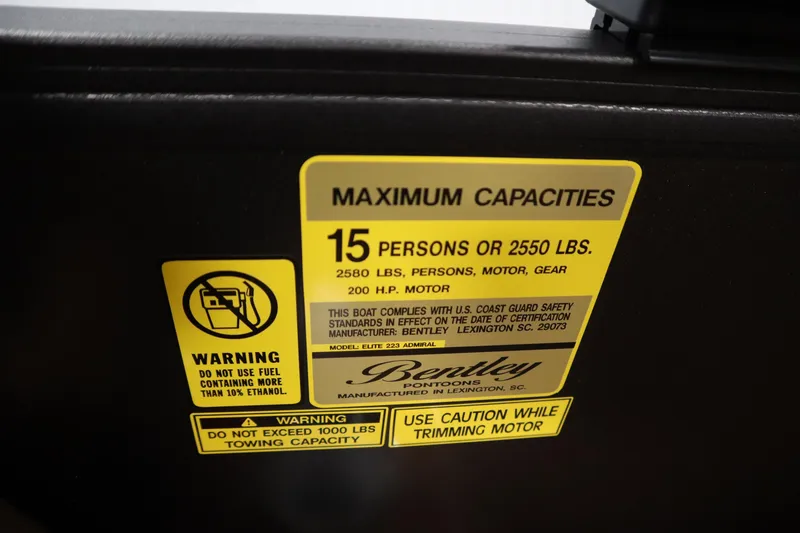 Slide: The Image of Warning label on 2026 Bentley Pontoons Elite 223 Admiral Tri-toon, detailing maximum capacities. - 27
