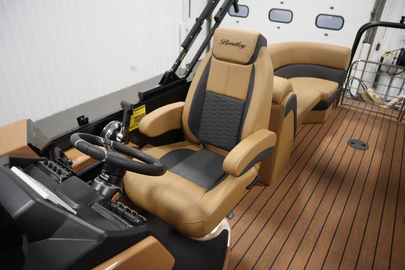 Slide: The Image of 2026 Bentley Pontoons Elite 223 Admiral Tri-toon interior with luxurious seating and steering console. - 28