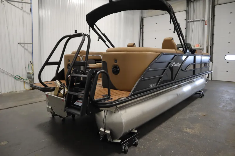 Slide: The Image of 2026 Bentley Pontoons Elite 223 Admiral Tri-toon in a warehouse setting. - 4