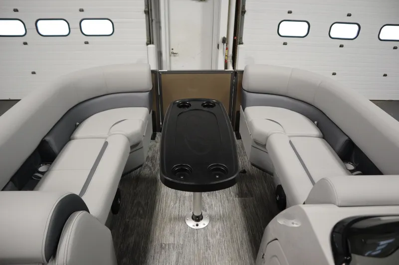 Slide: The Image of 2026 Bentley Pontoons Legacy 223 Swingback Tri-toon interior with plush seating and table. - 10