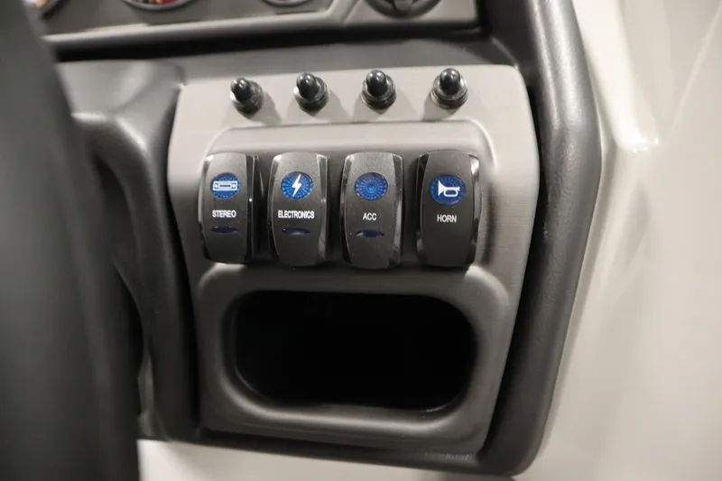 Slide: The Image of Control panel of 2026 Bentley Pontoons Legacy 223 with labeled switches for stereo, electronics, and horn. - 23