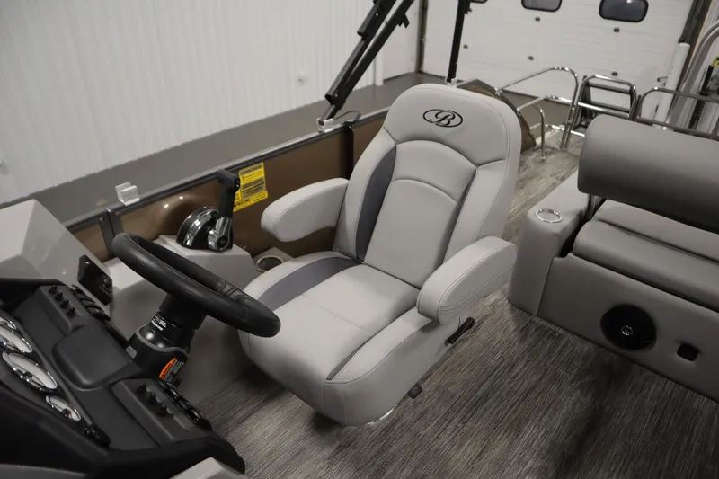 Slide: The Image of 2026 Bentley Pontoons Legacy 223 Swingback Tri-toon interior with captain's chair and steering console. - 25