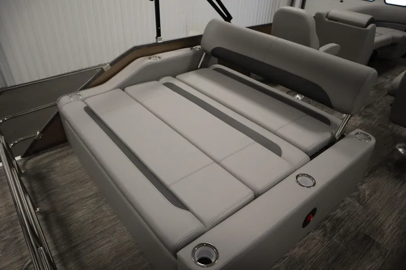 Slide: The Image of 2026 Bentley Pontoons Legacy 223 Swingback Tri-toon interior with luxurious seating and cup holders. - 27