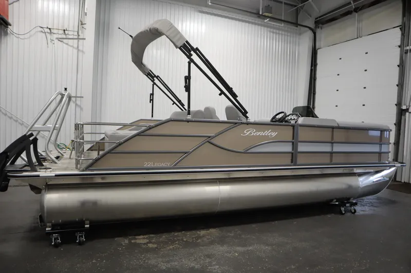 Slide: The Image of 2026 Bentley Pontoons Legacy 223 Swingback Tri-toon in a showroom setting. - 3
