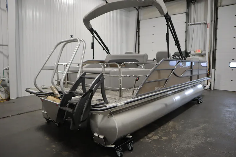 Slide: The Image of 2026 Bentley Pontoons Legacy 223 Swingback Tri-toon in a showroom, showcasing sleek design and features. - 4