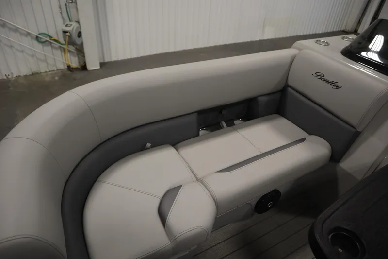Slide: The Image of 2026 Bentley Pontoons LEGACY 223 NAVIGATOR TRI-TOON interior seating, featuring luxurious gray upholstery. - 14