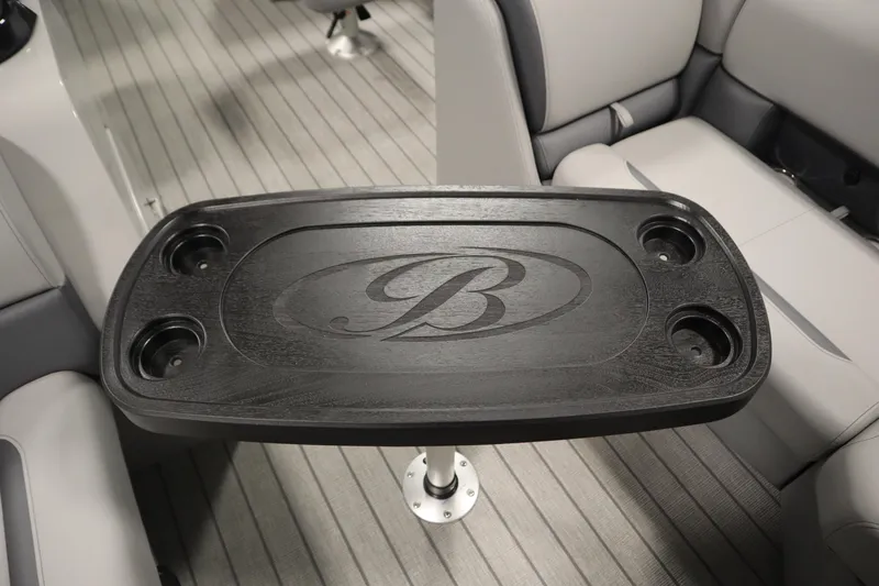 Slide: The Image of 2026 Bentley Pontoons LEGACY 223 NAVIGATOR TRI-TOON interior with sleek table and cup holders. - 16