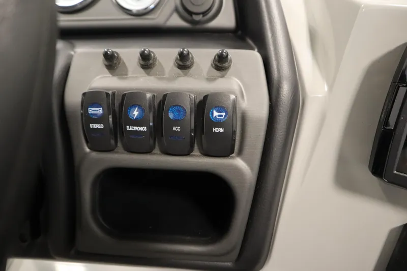 Slide: The Image of Control panel of 2026 Bentley Pontoons LEGACY 223 NAVIGATOR TRI-TOON with labeled switches. - 23