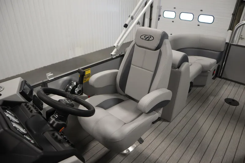 Slide: The Image of 2026 Bentley Pontoons LEGACY 223 NAVIGATOR TRI-TOON interior with luxurious captain's chair and controls. - 28