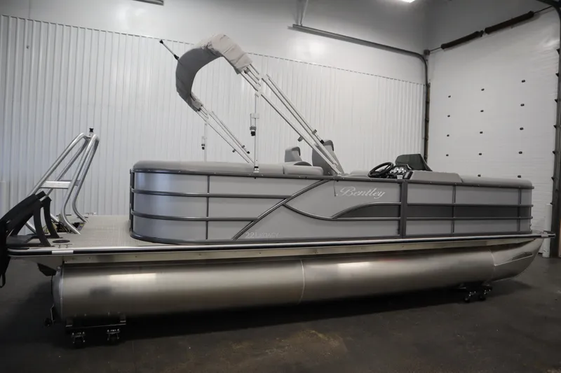Slide: The Image of 2026 Bentley Pontoons LEGACY 223 NAVIGATOR TRI-TOON in a showroom, side view. - 3