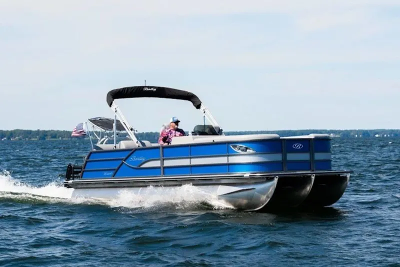 Slide: The Image of 2026 Bentley Pontoons LEGACY 223 NAVIGATOR TRI-TOON cruising on a lake. - 43