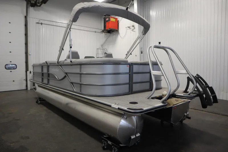 Slide: The Image of 2026 Bentley Pontoons Legacy 223 Navigator Tri-Toon in a showroom, side view. - 6