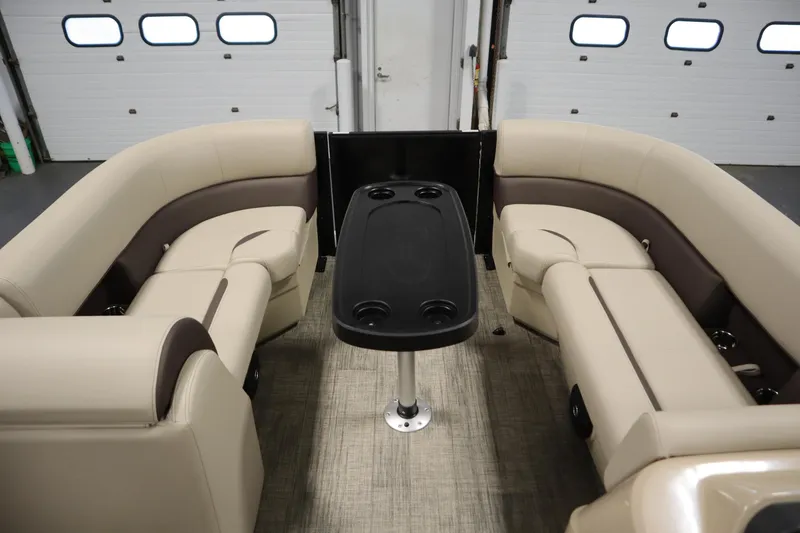 Slide: The Image of 2026 Bentley Pontoons LE 200 CW interior with beige seating and central table. - 10