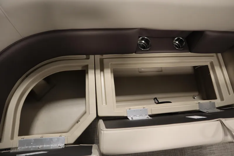 Slide: The Image of 2026 Bentley Pontoons LE 200 CW interior storage compartments with beige and brown accents. - 15