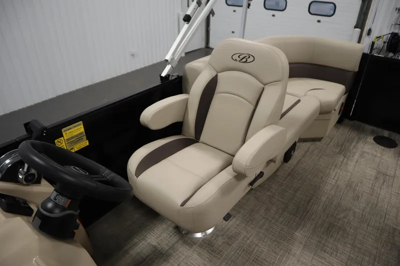 Slide: The Image of 2026 Bentley Pontoons LE 200 CW interior with beige seating and steering wheel. - 25