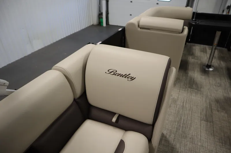 Slide: The Image of 2026 Bentley Pontoons LE 200 CW interior with beige and brown seating. - 27